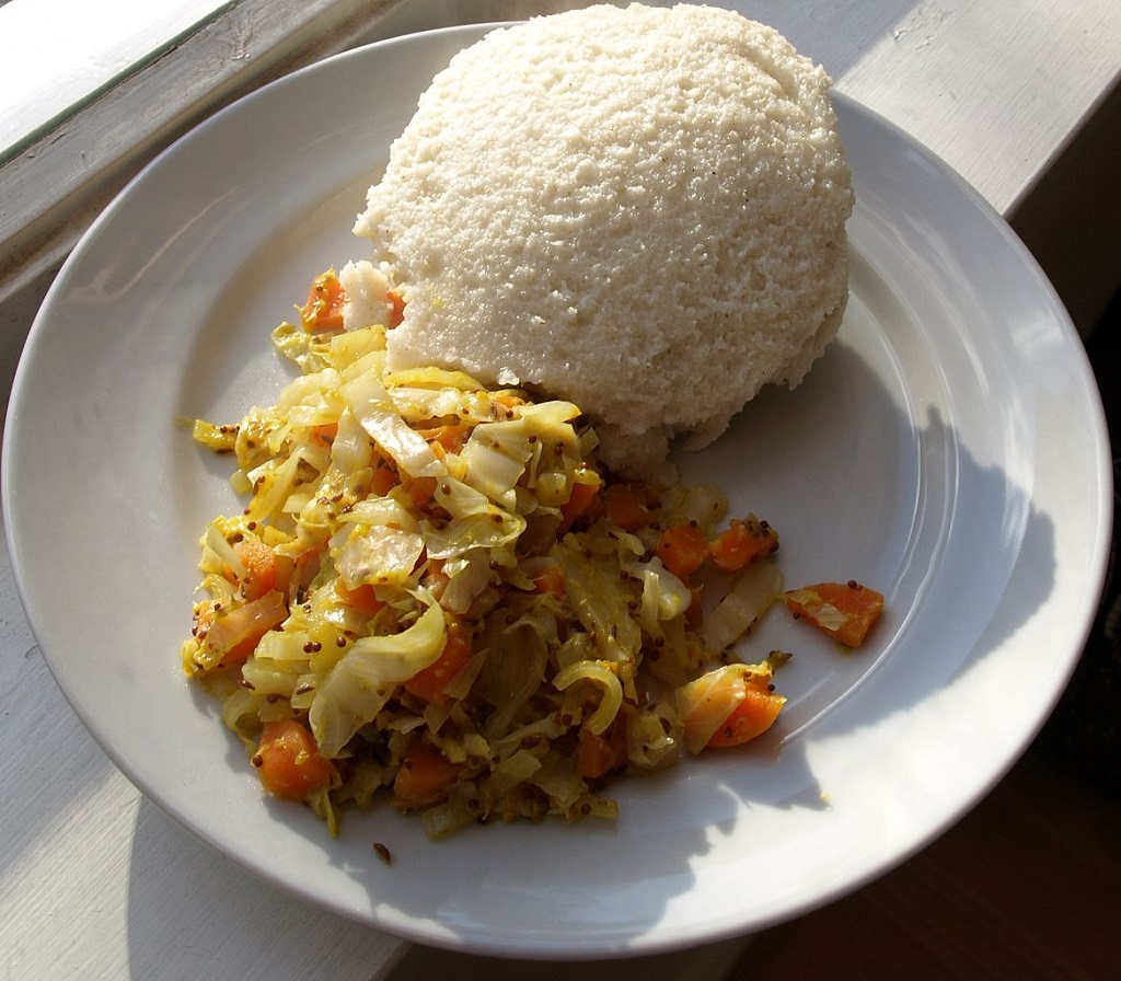 image of as serving of ugali and stir fry cabbage