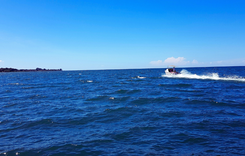 speed boat on the water on a clear day off the coat of rusinga island in lake victoria portion of kenya