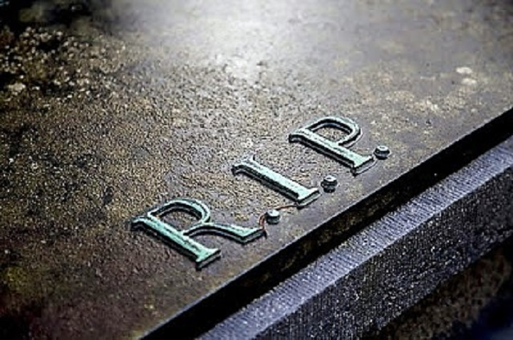 closeup of tombstone with R.I.P initials