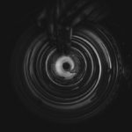 grayscale image of potter working on spin table. pottery is the subject of many luhya proverbs and sayings