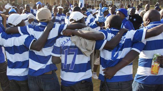 AFC leopards fans huddle together in a show of the spirit of mulembe
