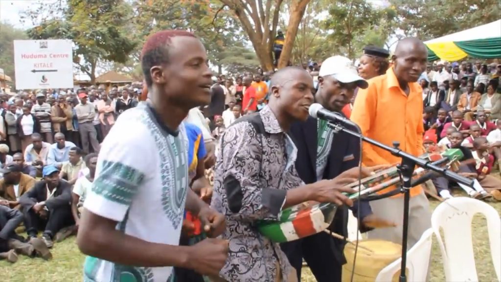 bindu bichenjanga performed live at a political event as crowd looks on