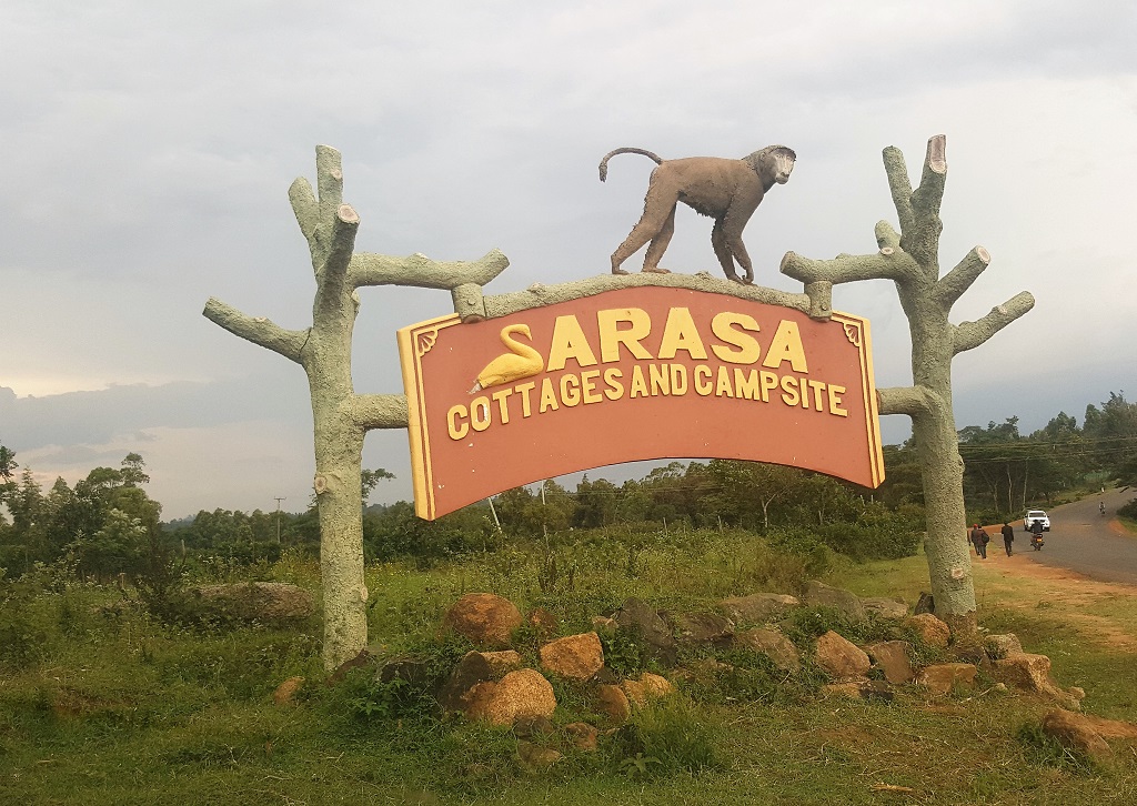 signage of sarasa cottates and campsite with sculpture of monkey atop