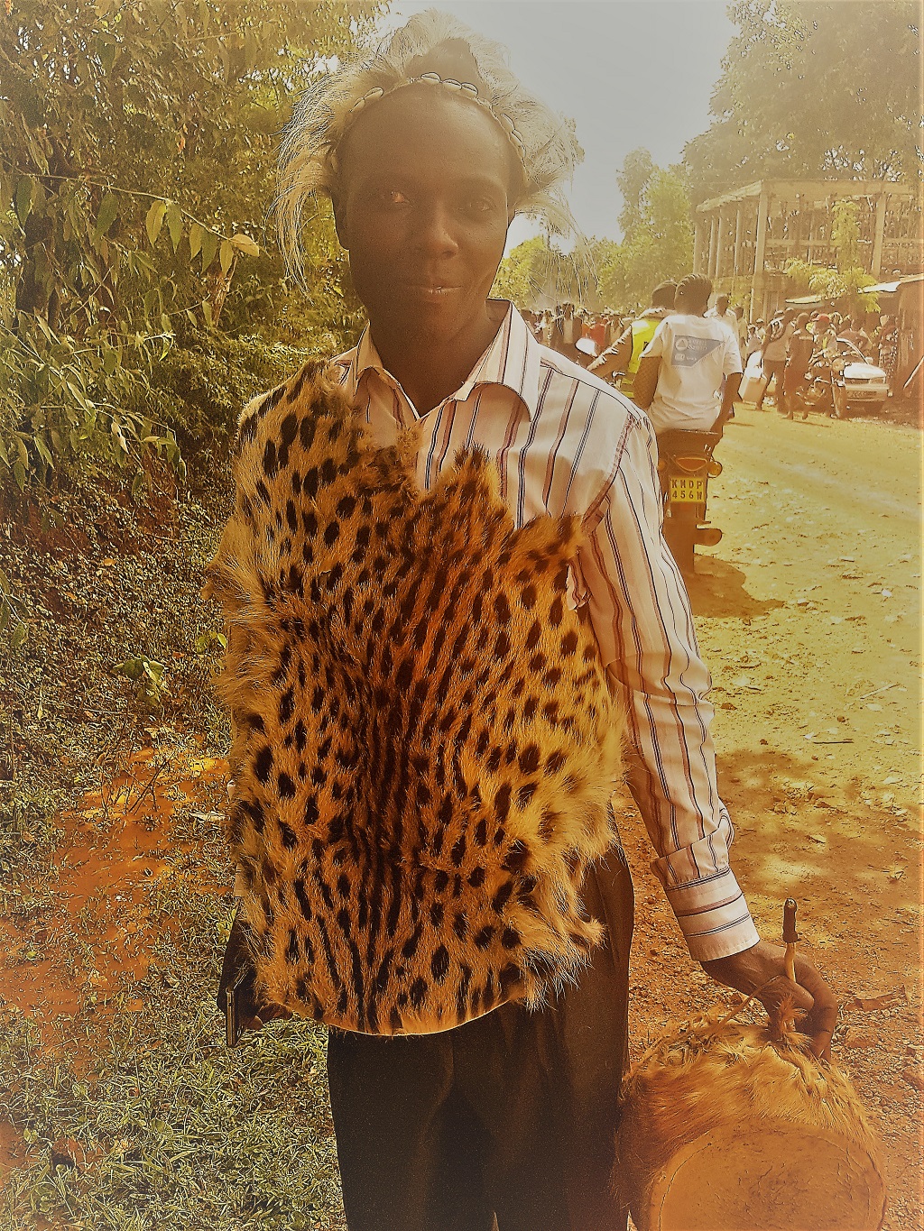 traditional circumciser donning a leopard skin