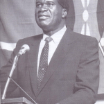 The father of Kimilili politics Elijah Mwangale on a podium with all the strappings of power of a government minister including the National flag