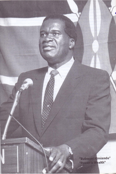 The father of Kimilili politics Elijah Mwangale on a podium with all the strappings of power of a government minister including the National flag